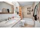 Bright bathroom featuring a tub with tiled accent wall and a granite topped sink at 1101 Essex N Dr, St Petersburg, FL 33710