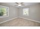 This bedroom features a ceiling fan and two windows that let in natural light at 1101 Essex N Dr, St Petersburg, FL 33710