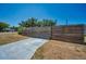 A long concrete driveway is enclosed with a modern horizontal wood fence under a bright blue sky at 1101 Essex N Dr, St Petersburg, FL 33710