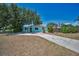 Inviting single-Gathering home featuring a vibrant yard and a long, pristine concrete driveway at 1101 Essex N Dr, St Petersburg, FL 33710