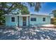 Charming single-story home featuring a welcoming front porch, complemented by fresh paint and a well-kept yard at 1101 Essex N Dr, St Petersburg, FL 33710