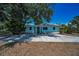 Charming single-story home with a well-kept yard and long driveway under a bright blue sky at 1101 Essex N Dr, St Petersburg, FL 33710
