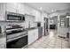 Modern kitchen featuring white cabinets, stainless steel appliances, and sleek countertops, perfect for culinary enthusiasts at 1101 Essex N Dr, St Petersburg, FL 33710