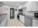 Stylish kitchen featuring ample counter space, modern appliances, and white cabinets with subway tile backsplash at 1101 Essex N Dr, St Petersburg, FL 33710