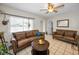 Inviting living room featuring tile flooring, a cozy seating arrangement, and a stylish ceiling fan at 1101 Essex N Dr, St Petersburg, FL 33710