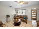 Comfortable living room with tile floors, a cozy sofa, and ample natural light from the large window at 1101 Essex N Dr, St Petersburg, FL 33710