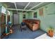 A cozy covered outdoor patio is furnished with a comfortable sofa, table, and decorative plants at 1101 Essex N Dr, St Petersburg, FL 33710