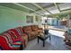 A cozy outdoor patio featuring a comfortable seating area under a covered roof, perfect for relaxation and entertainment at 1101 Essex N Dr, St Petersburg, FL 33710
