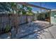 An outdoor patio offers a relaxing space with a wooden pergola, a chair, and views of the backyard at 1101 Essex N Dr, St Petersburg, FL 33710