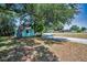 Side view of a light blue house with well-maintained grass and ample space to add your personal touches at 1101 Essex N Dr, St Petersburg, FL 33710