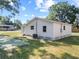 Exterior view of the home with a backyard and well-maintained lawn at 1108 E Annie St, Tampa, FL 33612