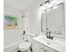 Clean bathroom with white tile, tub, and modern vanity at 1108 E Annie St, Tampa, FL 33612