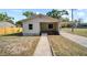 Charming single-story home featuring a covered front porch and carport at 1108 E Annie St, Tampa, FL 33612