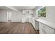 Modern kitchen with quartz counters, wood flooring, and stainless steel faucet at 1108 E Annie St, Tampa, FL 33612