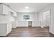 Bright and airy kitchen featuring white cabinets and countertops with wood-look flooring at 1108 E Annie St, Tampa, FL 33612