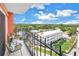 Relaxing balcony with black iron railing overlooking lush greenery and city buildings under a bright blue sky at 1120 N Shore Ne Dr # 804, St Petersburg, FL 33701