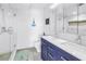 Modern bathroom featuring double sinks, a walk-in shower, and a blue vanity at 1120 N Shore Ne Dr # 804, St Petersburg, FL 33701