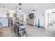Open-concept living room boasts a surfboard dining table, white tile floors, and stylish decor at 1120 N Shore Ne Dr # 804, St Petersburg, FL 33701
