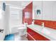 Bright bathroom with a modern red vanity, mosaic tile accent wall, and shower-over-tub at 1120 North Shore Ne Dr # 804, St Petersburg, FL 33701