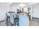 Kitchen with bar-height counter and gray chairs, white cabinets, stainless steel appliances, and tile flooring at 1120 North Shore Ne Dr # 804, St Petersburg, FL 33701