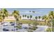 Scenic view of a parking lot adjacent to a beach with palm trees and ocean, offering convenient access to waterfront amenities at 1120 N Shore Ne Dr # 804, St Petersburg, FL 33701