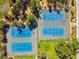 Overhead view of well-maintained blue and green tennis courts surrounded by trees and greenery at 1120 N Shore Ne Dr # 804, St Petersburg, FL 33701