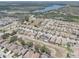 An aerial view of a residential neighborhood adjacent to a lake, complete with manicured lawns at 11222 Hawks Fern Dr, Riverview, FL 33569