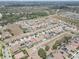 An aerial view of a housing community featuring landscaping, a water tower, and tidy street layouts at 11222 Hawks Fern Dr, Riverview, FL 33569