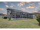 Large backyard with a screened-in pool area, well-maintained lawn, and view of the home's exterior at 11222 Hawks Fern Dr, Riverview, FL 33569