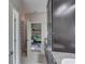 Bathroom featuring dark cabinets and a view into the bedroom at 11222 Hawks Fern Dr, Riverview, FL 33569