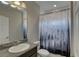 Bathroom with a stylish shower curtain, granite countertops, and updated fixtures at 11222 Hawks Fern Dr, Riverview, FL 33569