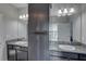 Modern bathroom featuring dual sinks, granite countertops, and gray cabinetry at 11222 Hawks Fern Dr, Riverview, FL 33569