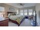 Bright bedroom featuring multiple windows, a ceiling fan and a rocking chair at 11222 Hawks Fern Dr, Riverview, FL 33569
