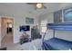 bedroom with bunk beds, ceiling fan, and wall-mounted TV at 11222 Hawks Fern Dr, Riverview, FL 33569