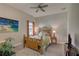 Cozy bedroom with a tropical-themed bed, a ceiling fan, and a picture on the wall at 11222 Hawks Fern Dr, Riverview, FL 33569
