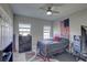 Comfortable bedroom with dark wood furniture, ceiling fan, and large window at 11222 Hawks Fern Dr, Riverview, FL 33569