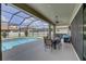 View of the outdoor space with ceiling fan, seating, and screened-in pool at 11222 Hawks Fern Dr, Riverview, FL 33569