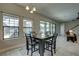 Bright dining area with table, chairs, and windows overlooking the backyard and pool area at 11222 Hawks Fern Dr, Riverview, FL 33569