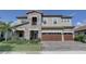 Charming two-story home with a stone facade and well-manicured landscaping at 11222 Hawks Fern Dr, Riverview, FL 33569
