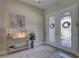 Beautiful foyer with double doors, neutral walls, and stylish console table at 11222 Hawks Fern Dr, Riverview, FL 33569