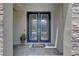 Elegant double front doors with decorative glass panels and stone accents at 11222 Hawks Fern Dr, Riverview, FL 33569