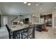 Open floor plan with kitchen island, dining area, and living room with a view of staircase at 11222 Hawks Fern Dr, Riverview, FL 33569