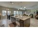 Kitchen island featuring granite countertops, stainless steel sink, and open layout to dining and living spaces at 11222 Hawks Fern Dr, Riverview, FL 33569