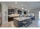 Stylish kitchen features dark cabinetry, granite countertops, and a large center island with seating at 11222 Hawks Fern Dr, Riverview, FL 33569