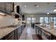 Spacious kitchen features granite countertops, stainless steel appliances, and dark wood cabinetry at 11222 Hawks Fern Dr, Riverview, FL 33569