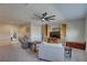 Spacious living room with a ceiling fan, comfortable seating, and built-in shelving at 11222 Hawks Fern Dr, Riverview, FL 33569