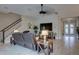 Comfortable living room showcasing the staircase, front door, and warm color palette at 11222 Hawks Fern Dr, Riverview, FL 33569