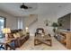 Comfortable living room with brown leather furniture, area rug, and ceiling fan, offering a relaxing space at 11222 Hawks Fern Dr, Riverview, FL 33569