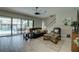 Inviting living room with sliding glass doors to lanai, comfortable seating, and a ceiling fan at 11222 Hawks Fern Dr, Riverview, FL 33569