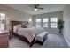 Inviting main bedroom featuring a large bed, dresser, and multiple windows for ample natural light at 11222 Hawks Fern Dr, Riverview, FL 33569